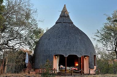 The exterior of a traditionally thatched chalet at Hoyo Hoyo Safari Lodge.