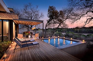 Lanterns light up a private villa at Lion Sands Ivory Lodge.