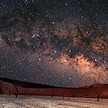 A starry night sky showing the Milky Way over the sand dunes of Sossusvlei.