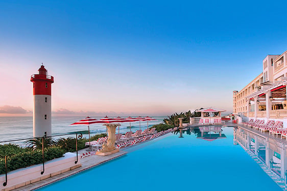 Swimming pool and red-and-white lighthouse at The Oyster Box hotel in Umhlanga.