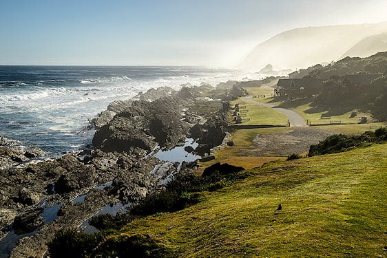 Rugged shoreline and wooden chalets along the Garden Route at Tsitsikamma.