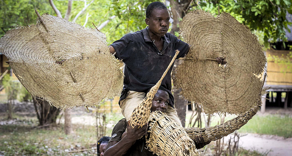 Two locals of Zambia showing their straw crafts.