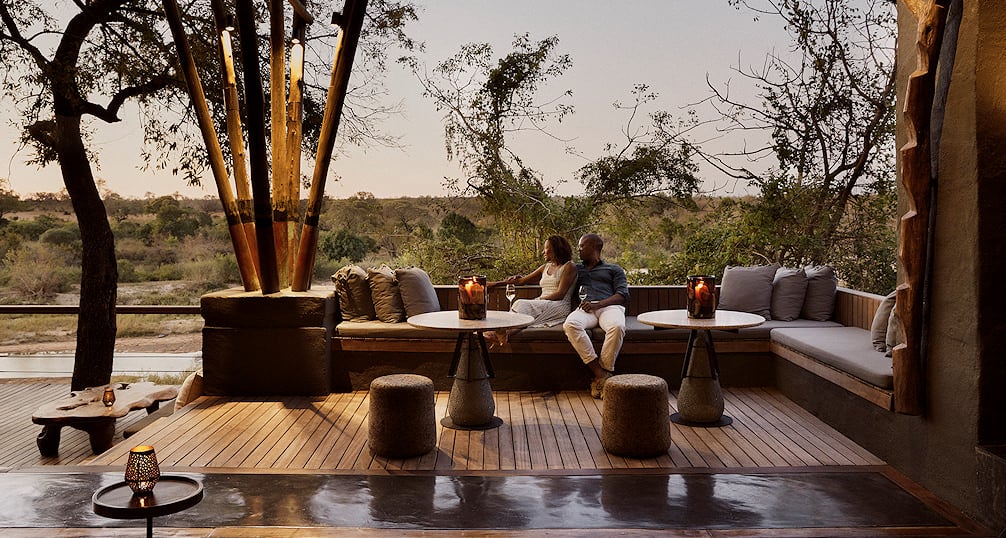 Elegant safari lodge suite with open veranda overlooking wildlife-rich plains in South Africa