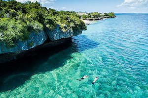 People swimming in the clear waters of Mozambique.