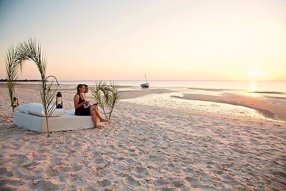 Couple enjoying a romantic beach setting.