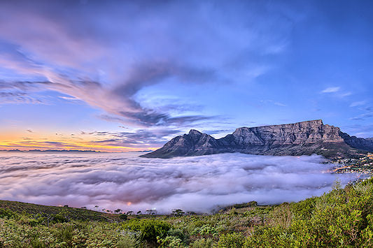 Clouds cover the city of Cape Town, with only Table Mountain visible.