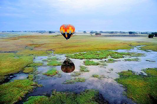 Hot air balloon hovering over Kafue National Park.