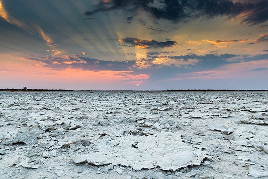 The barren salt flats of Nxai Pan at sunset.