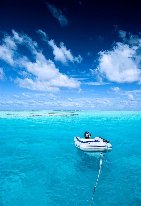 Lone rubber dinghie on the azure ocean.