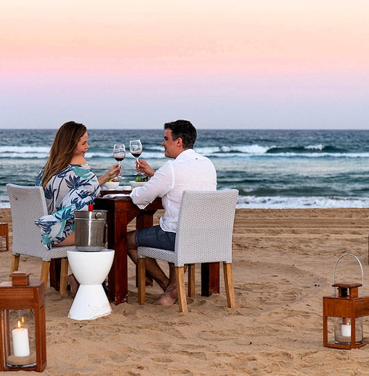 A couple dining on the beach at White Pearl Resorts, Mozambique.
