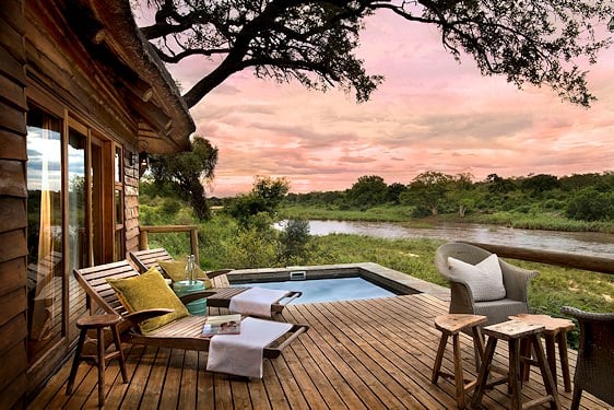 Dinner is prepared under an ancient riverside tree at Lion Sands Narina Lodge.