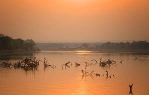 The sun sets over the Luangwa River in Zambia.