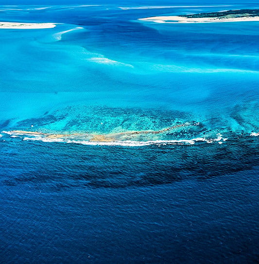 An aerial view of the turquoise ocean channels and white sandbars of the Bazaruto Archipelago.