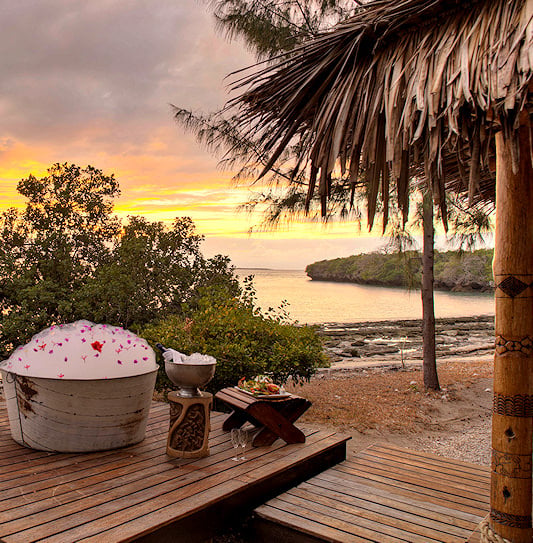 An outdoor bathtub on a beach deck at a luxury resort in the Quirimbas Archipelago, Mozambique.