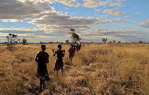 San bushmen set off through the veld.
