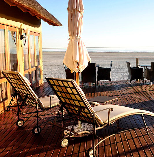 Sun deck with loungers and outdoor tables facing the Etosha Pan.