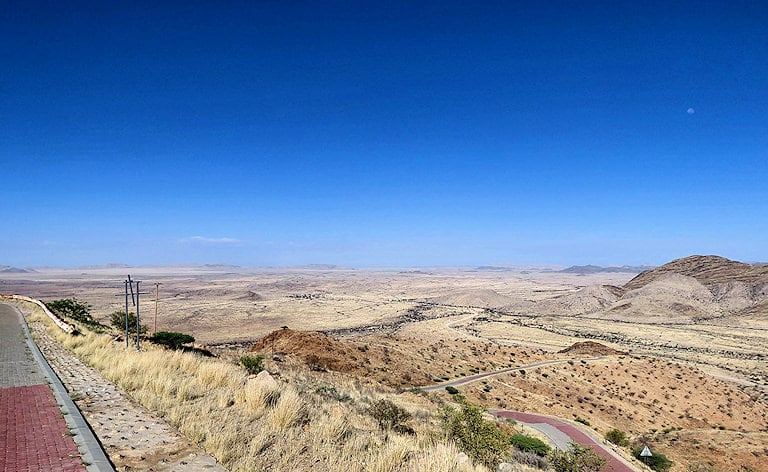 High-angle view from a paved mountain pass looking down across vast desert plains, Spreetshoogte Pass, Namibia.