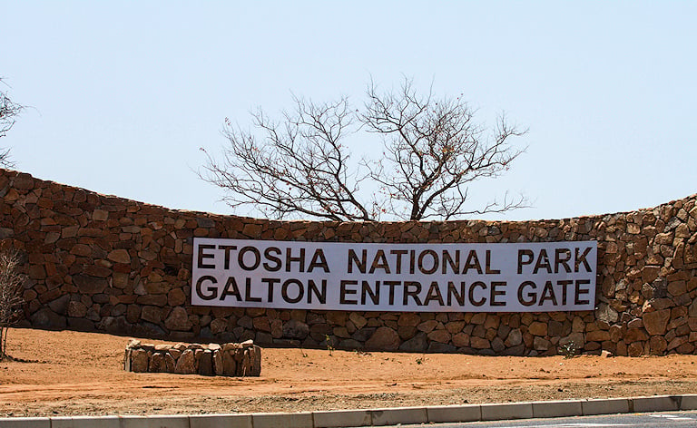 Stone entrance wall and sign for Galton Entrance Gate, Etosha National Park, Namibia
