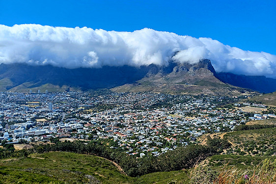 Overview of Cape Town with clouds blanketed over Table Mountain.