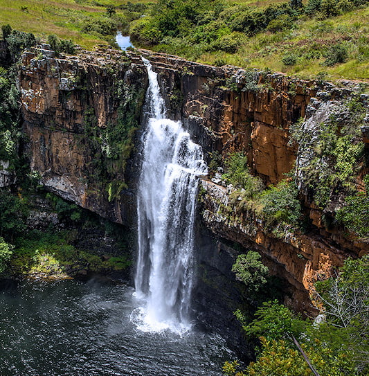 Berlin Falls dropping from a rocky cliff into a pool, Mpumalanga.