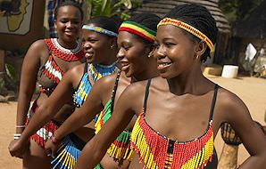 Girls at a cultural village dressed in beaded outfits.