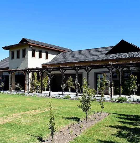 Tiled estate house behind a timber trellis driveway in Knysna.