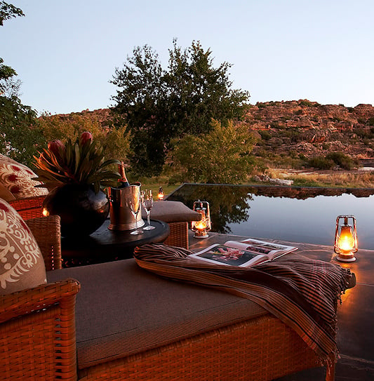 Lanterns around a private plunge pool below sandstone cliffs, Cederberg.