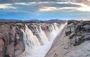 The sun sets over the grand gurgle of the Augrabies Falls.