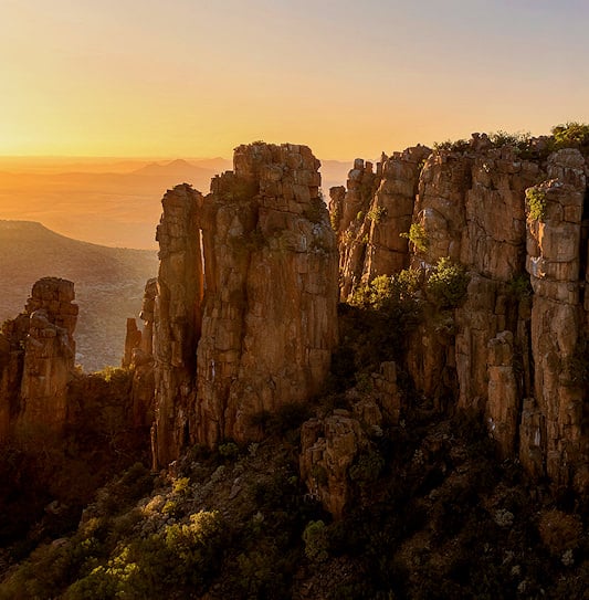 The massive dolerite rock pillars of the Valley of Desolation in Camdeboo National Park, illuminated by golden sunset light.