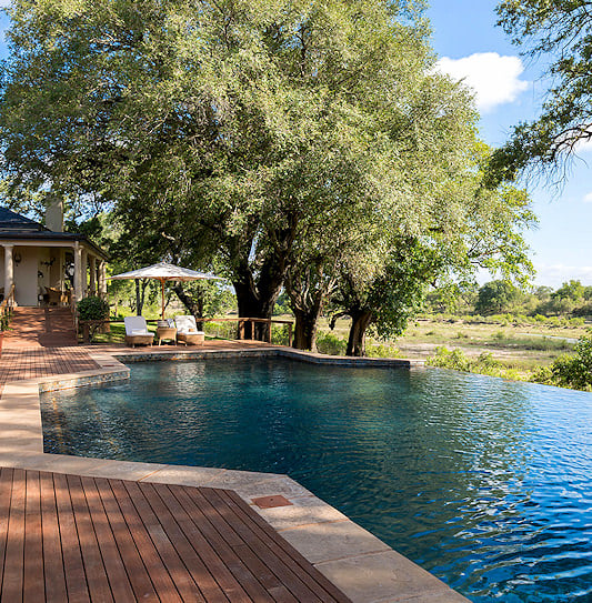 A view of the large infinity pool at the stylish Rattray's Lodge, overlooking the wilderness in the MalaMala Game Reserve, South Africa.