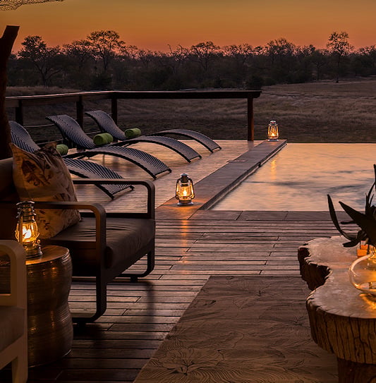 A deck with a pool and lanterns at Arathusa Safari Lodge, overlooking the Sabi Sands wilderness, South Africa.