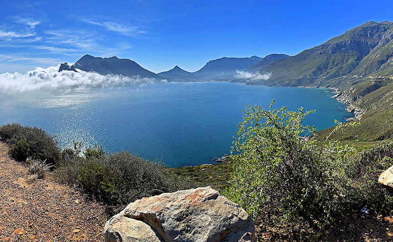 Ocean bay with low clouds rolling over the mountains, Chapman's Peak Drive, Cape Town