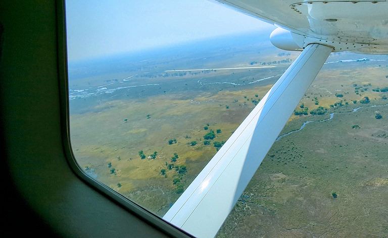 View of grassy channels from a small airplane window, Okavango Delta, Botswana.