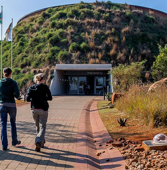 People walking towards the Maropeng Visitor Centre entrance, South Africa.