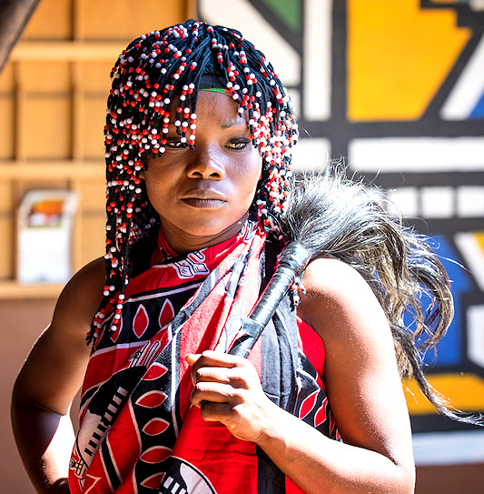 Close-up of an African woman in traditional attire at Lesedi Cultural Village, South Africa.