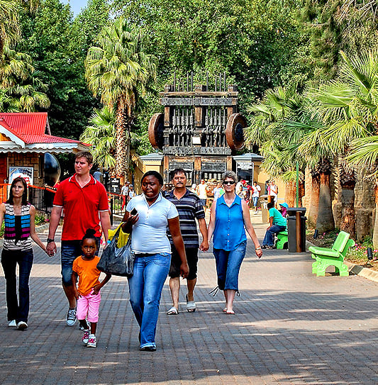 Visitors strolling through the theme park at Gold Reef City in Johannesburg, South Africa.