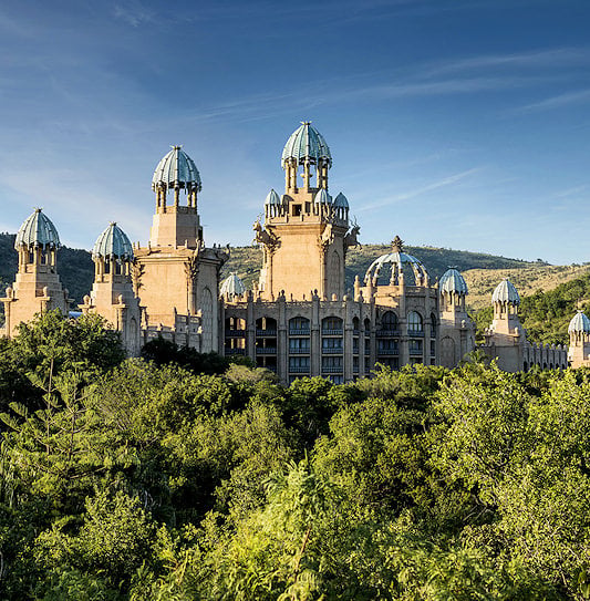 Palace of the Lost City surrounded by the Pilanesberg Mountains, South Africa.