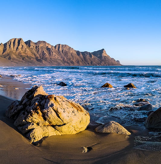 The Kogelberg Mountains behind the beach along Clarence Drive.