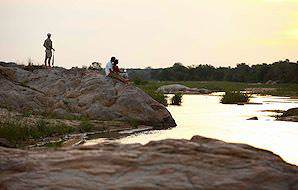 Kirkmans Camp guests enjoy a sundowner while overlooking the river.