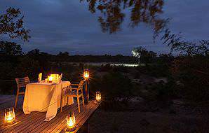 A private dinner with a view of the wilderness at Simbambili Lodge.