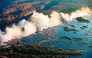 Thick mists billow up above the Victoria Falls.
