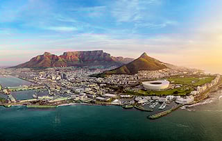 Aerial view of Cape Town with Table Mountain in the distance.