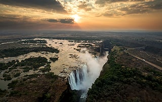Aerial view of Victoria Falls at sunset.